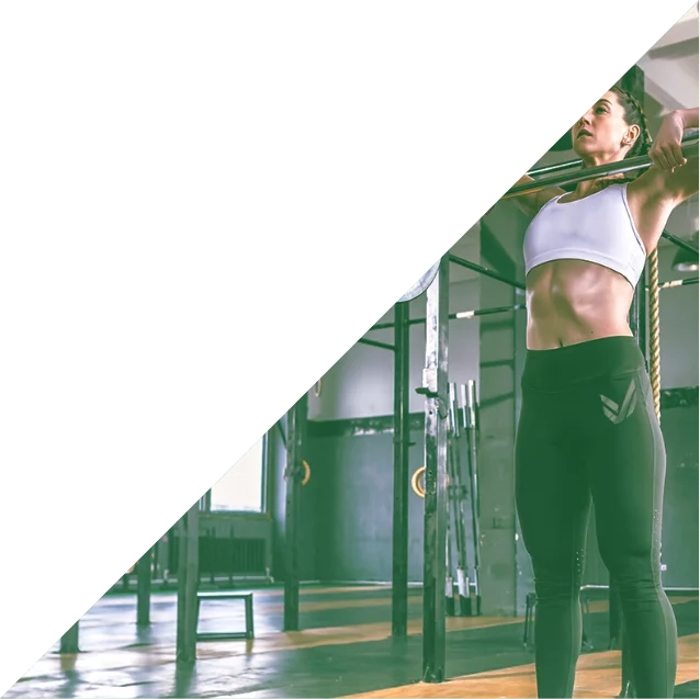 A fit woman in the middle of completing a power clean.