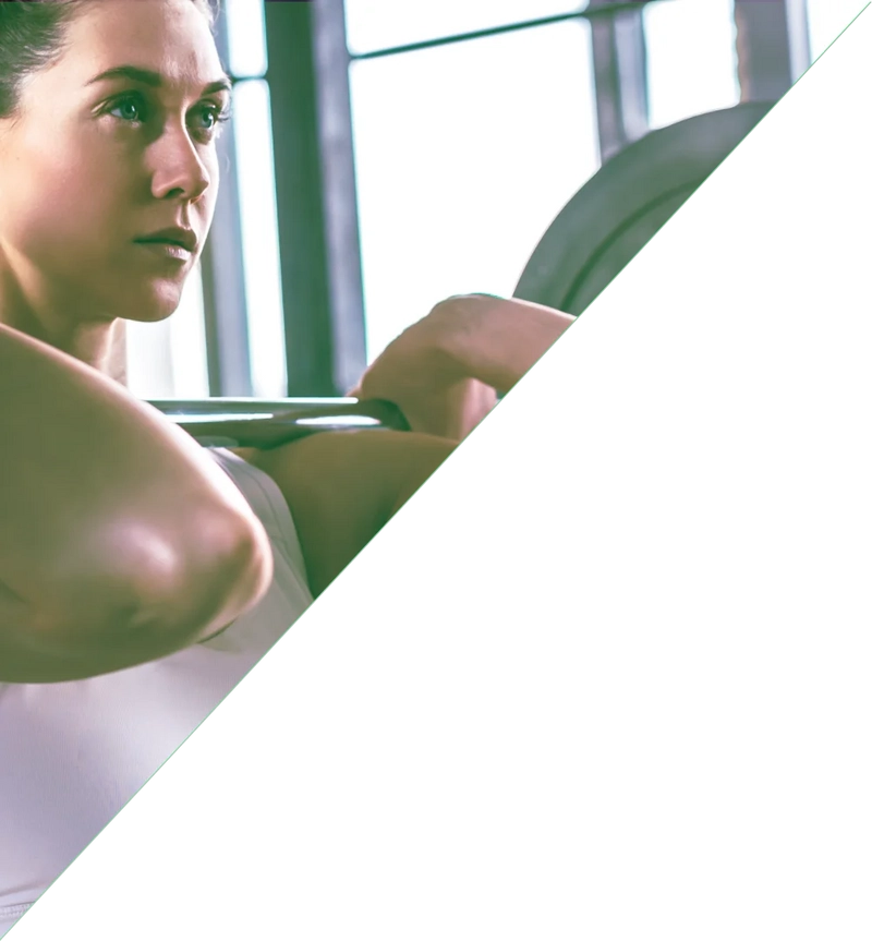 Fitfarm female member standing tall after performin a power clean.